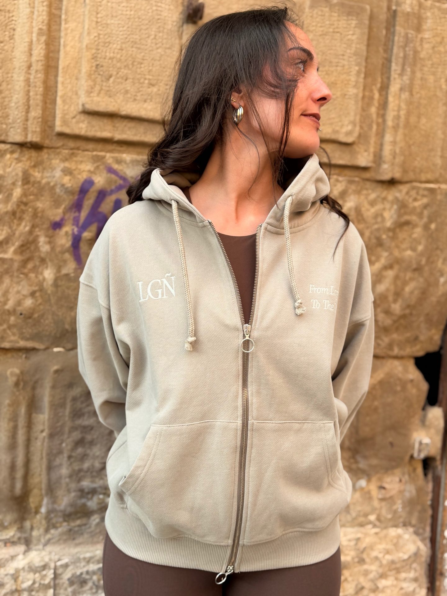 LGÑ Oversized Sand Zip-up Hoodie Streetwear.jpeg Front view of the LGÑ oversized sand zip-up hoodie with front embroidery and double-slider zipper.