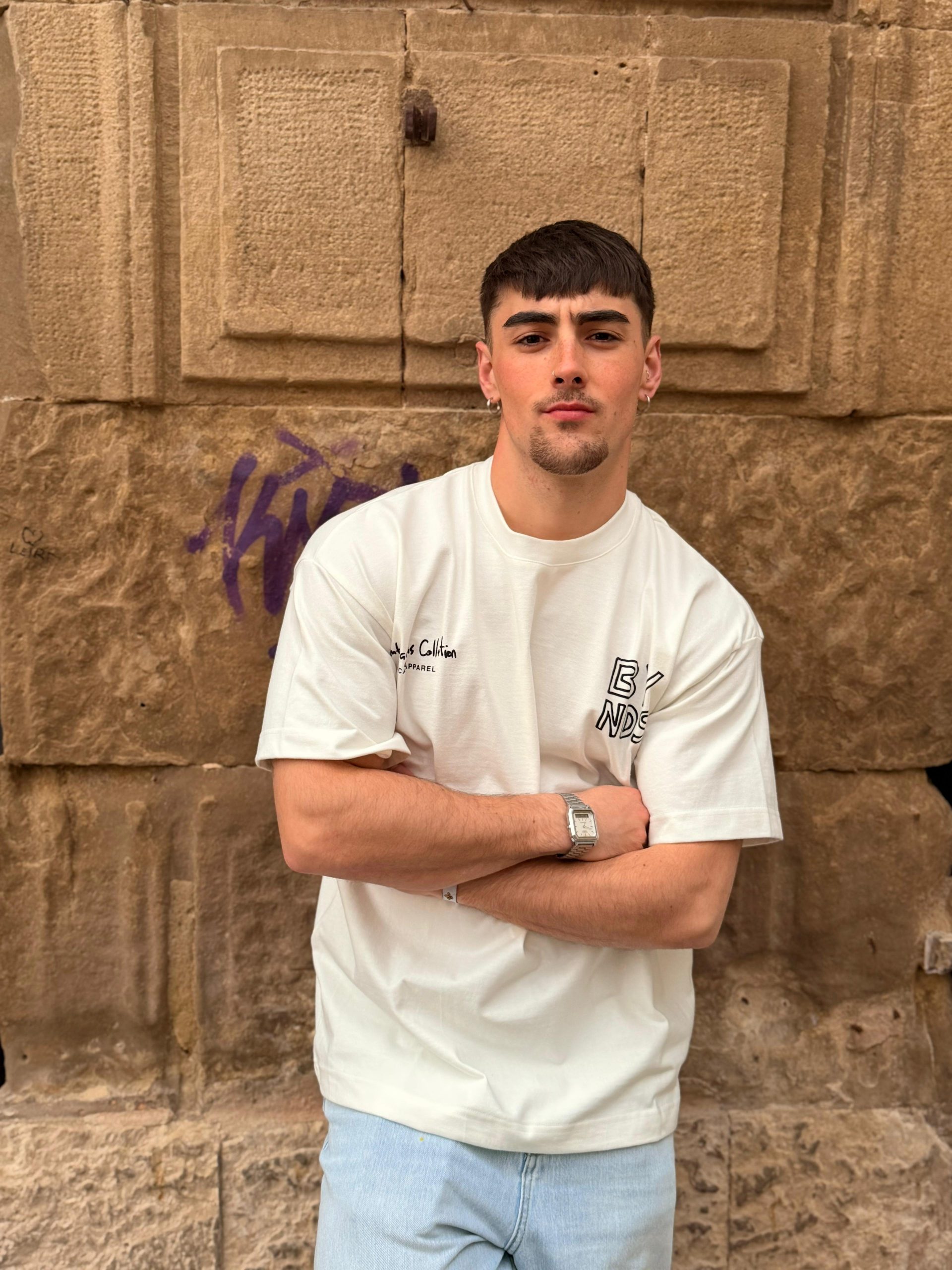 BYNDS Ambasaguas Heavy Cotton Tee. Person wearing a white Ambasaguas heavy cotton t-shirt from the BYNDS collection.